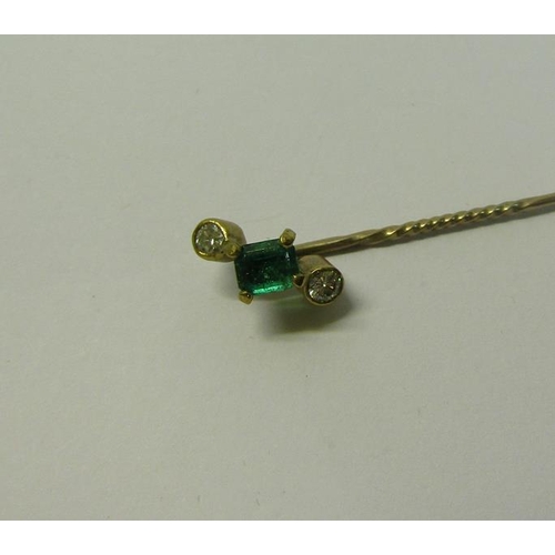 186 - A gold Emerald and Diamond set stick pin, 5.5cms l.