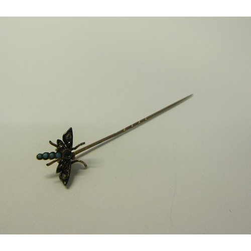 187 - A gold insect stick pin set with Turquoise and Diamond in the form of a Dragonfly.  6cms l.