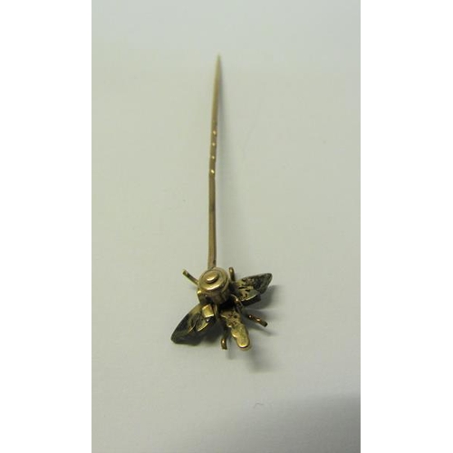 187 - A gold insect stick pin set with Turquoise and Diamond in the form of a Dragonfly.  6cms l.