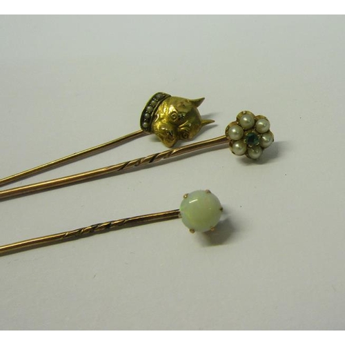 190 - A collection of three gold stick pins, one set with Emerald and Seed Pearl, one set Opal, the other ... 