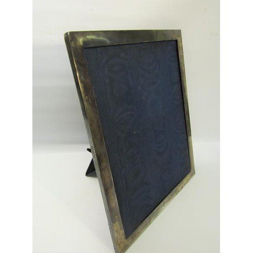 276 - An Edwardian silver cased photo frame of plain form, London 1909, 31cms x 38.5cms.