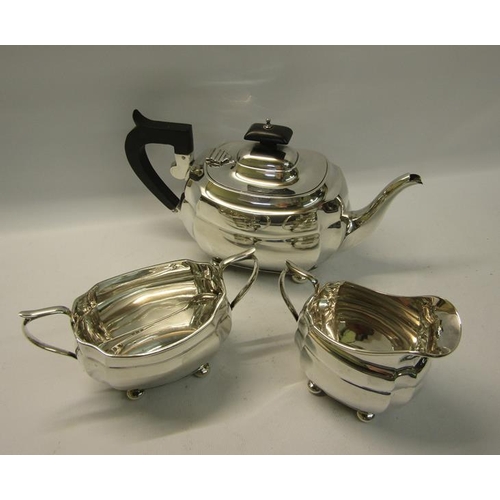 299 - A three piece silver tea service of squat baluster form comprising a teapot, sucrier and cream jug. ... 