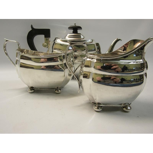 299 - A three piece silver tea service of squat baluster form comprising a teapot, sucrier and cream jug. ... 