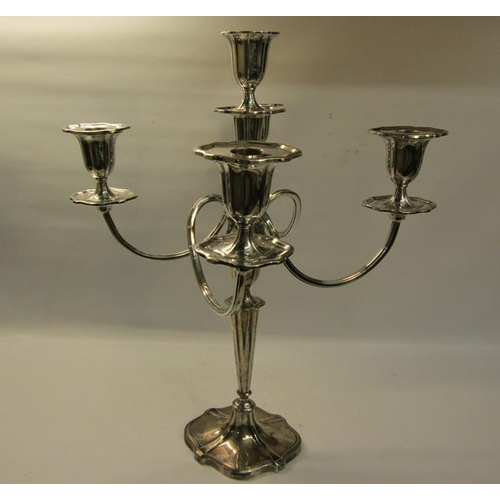 300 - A silver four branch candelabra with central stick on a tapering column with shaped domed base, fill... 