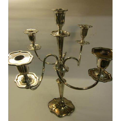 300 - A silver four branch candelabra with central stick on a tapering column with shaped domed base, fill... 