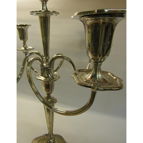 300 - A silver four branch candelabra with central stick on a tapering column with shaped domed base, fill... 