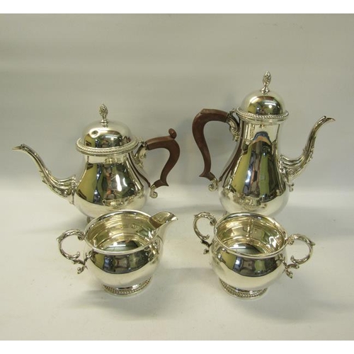 301 - A four piece silver tea and coffee service of baluster form, the teapot and coffee pot with hinged d... 