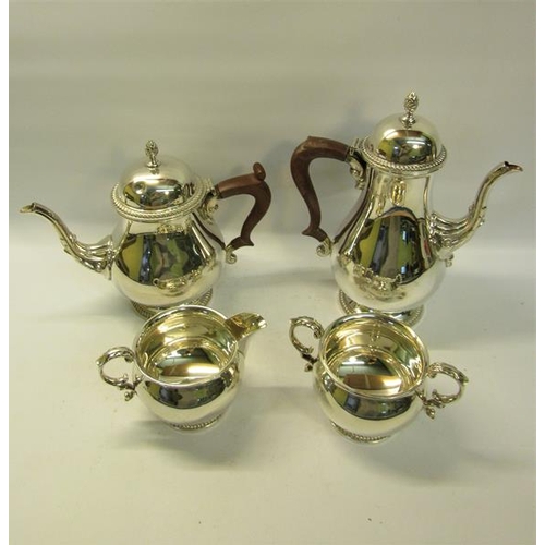 301 - A four piece silver tea and coffee service of baluster form, the teapot and coffee pot with hinged d... 