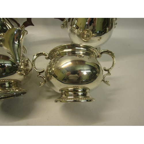 301 - A four piece silver tea and coffee service of baluster form, the teapot and coffee pot with hinged d... 