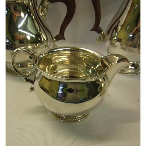 301 - A four piece silver tea and coffee service of baluster form, the teapot and coffee pot with hinged d... 