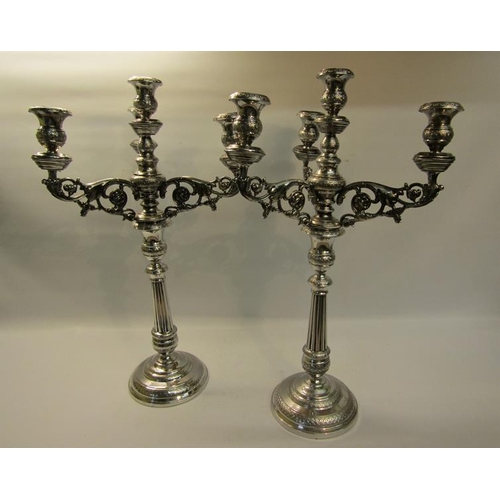 303 - A pair of 19c silver three branch candelabra's with knot fluted tapering columns and raised on stepp... 