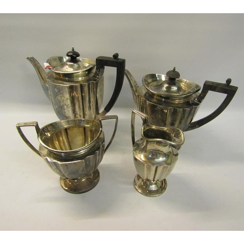 304 - An Edwardian four piece fluted silver tea and coffee service with angular handles, each piece on a c... 