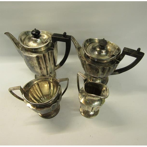 304 - An Edwardian four piece fluted silver tea and coffee service with angular handles, each piece on a c... 