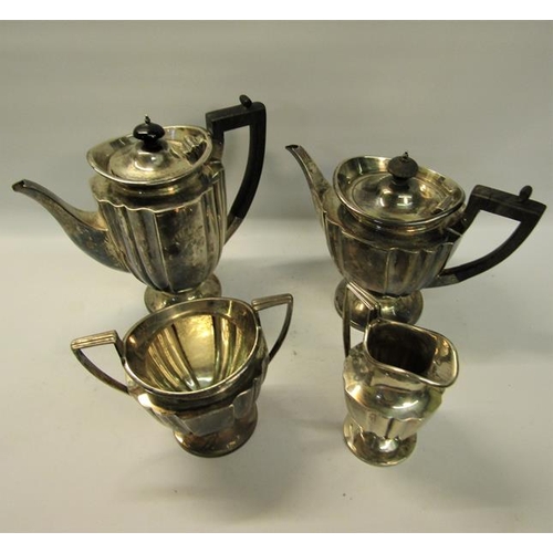 304 - An Edwardian four piece fluted silver tea and coffee service with angular handles, each piece on a c... 