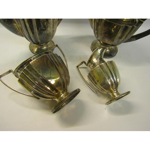 304 - An Edwardian four piece fluted silver tea and coffee service with angular handles, each piece on a c... 