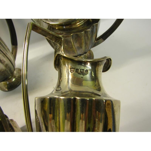 304 - An Edwardian four piece fluted silver tea and coffee service with angular handles, each piece on a c... 