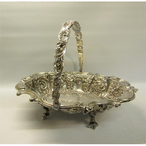 306 - A late Victorian silver basket with swing handle.  The basket with a shaped gadrooned formed rim wit... 