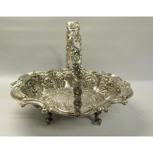 306 - A late Victorian silver basket with swing handle.  The basket with a shaped gadrooned formed rim wit... 