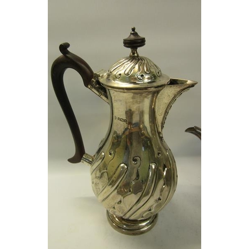 308 - A four piece silver tea and coffee service of baluster form.  The coffee and tea pot with hinged, sl... 