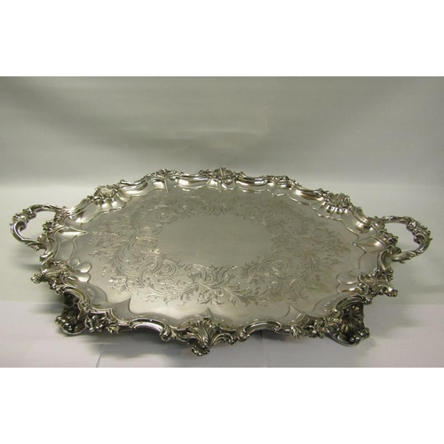 316 - A mid Victorian silver two handled tray with a raised and shaped leaf and scroll formed border, chas... 