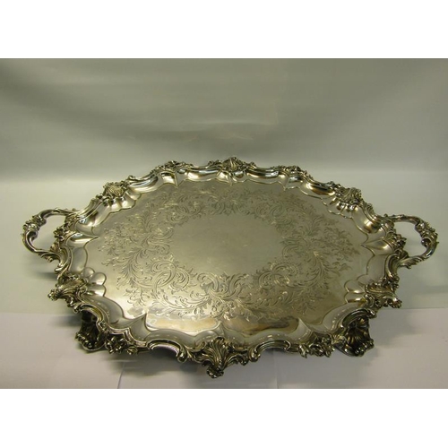 316 - A mid Victorian silver two handled tray with a raised and shaped leaf and scroll formed border, chas... 