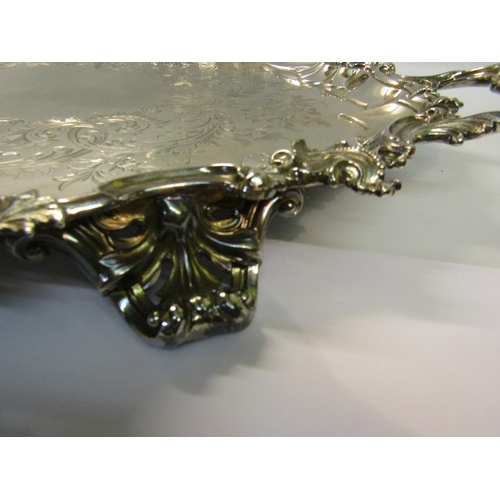 316 - A mid Victorian silver two handled tray with a raised and shaped leaf and scroll formed border, chas... 