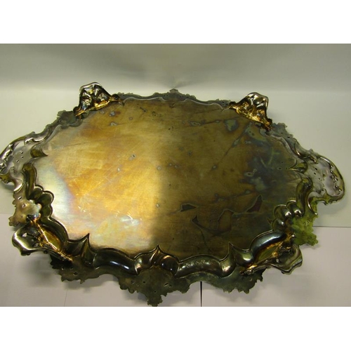 316 - A mid Victorian silver two handled tray with a raised and shaped leaf and scroll formed border, chas... 