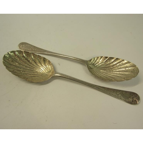 244 - A pair of 19c decorative table spoons with floral engraved shell shaped bowls and chased handles.  M... 