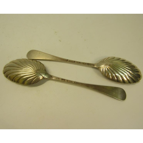 244 - A pair of 19c decorative table spoons with floral engraved shell shaped bowls and chased handles.  M... 