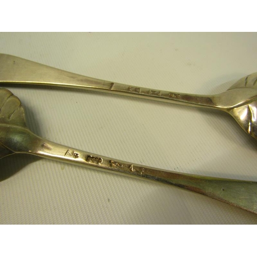 244 - A pair of 19c decorative table spoons with floral engraved shell shaped bowls and chased handles.  M... 