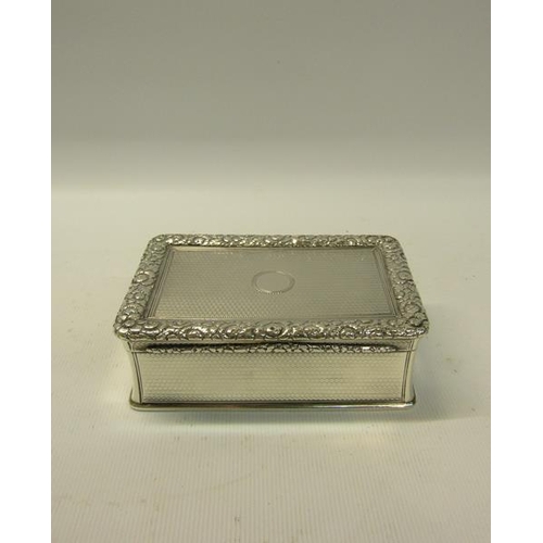 250 - An early Victorian silver table snuff box of rectangular form, the hinge cover with a cast border of... 