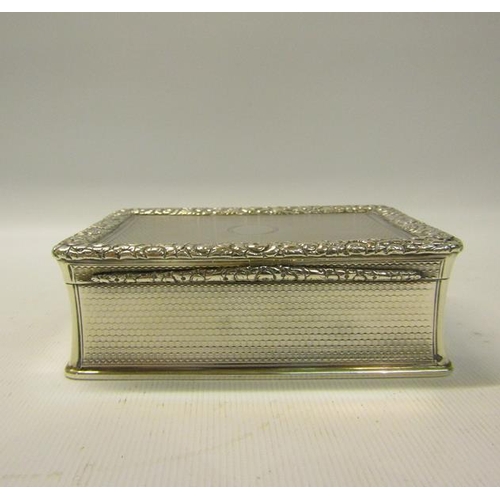 250 - An early Victorian silver table snuff box of rectangular form, the hinge cover with a cast border of... 