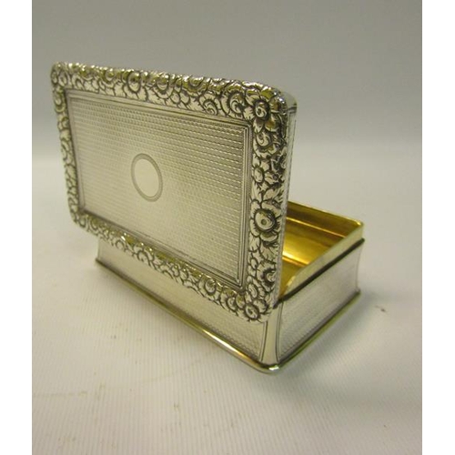 250 - An early Victorian silver table snuff box of rectangular form, the hinge cover with a cast border of... 