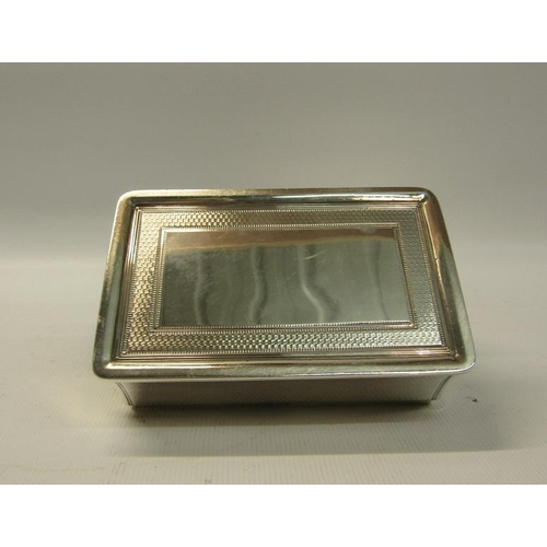 250 - An early Victorian silver table snuff box of rectangular form, the hinge cover with a cast border of... 