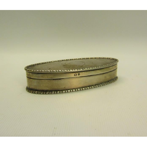 217 - An Edwardian silver toothpick box of oval form with beaded rim, engine turned and enclosed by a hing... 