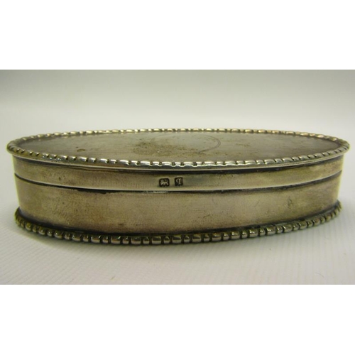 217 - An Edwardian silver toothpick box of oval form with beaded rim, engine turned and enclosed by a hing... 