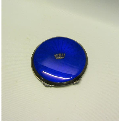 218 - An early 20c silver and blue enamel compact of circular form with hinged cover having crown motif.  ... 