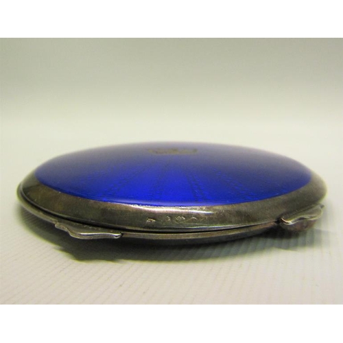 218 - An early 20c silver and blue enamel compact of circular form with hinged cover having crown motif.  ... 