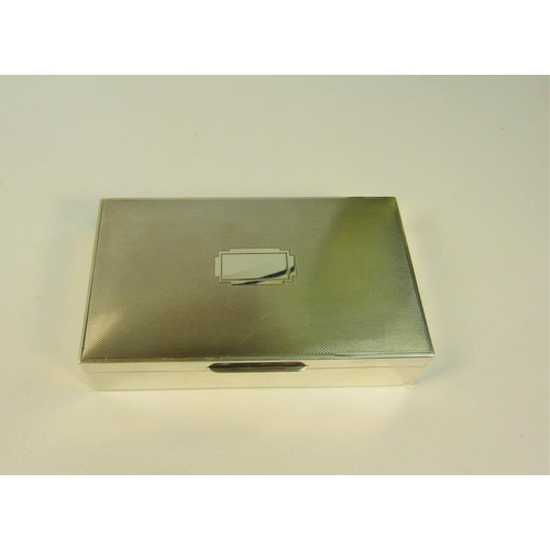 219 - A 20c silver cigarette box of rectangular form, the hinged cover engine turned.  Makers mark for Map... 