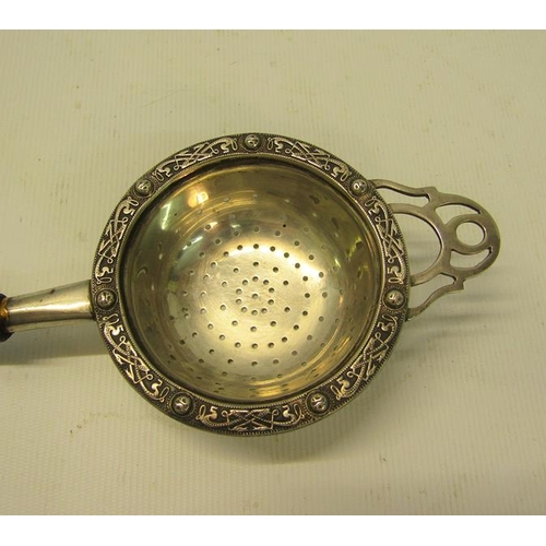 220 - A 20c silver tea strainer with turned wood handle.  Makers mark for C J Vander, London 1952.  19cms ... 