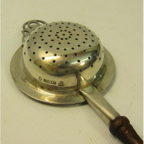 220 - A 20c silver tea strainer with turned wood handle.  Makers mark for C J Vander, London 1952.  19cms ... 