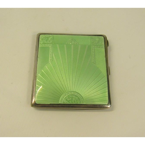 221 - An art deco silver and enamel cigarette box, the green enamel cover with a sunburst design.  London ... 