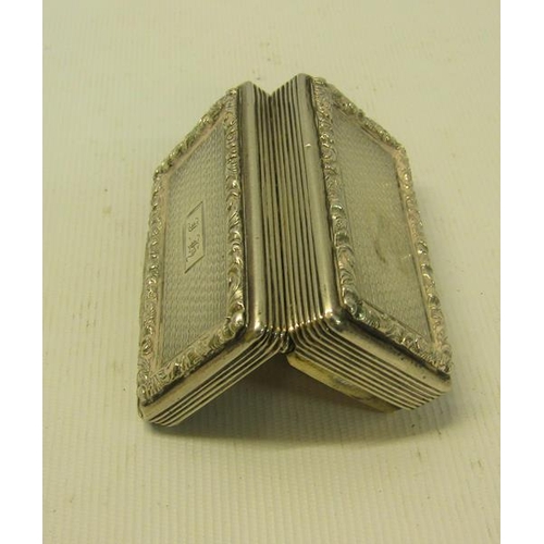 227 - A William IV silver snuff box of rectangular form, the box with ribbed decoration and leaf and flowe... 