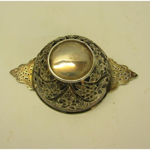 228 - A George III silver quaich shaped bowl, pierced and floral embossed and chased with two side handles... 