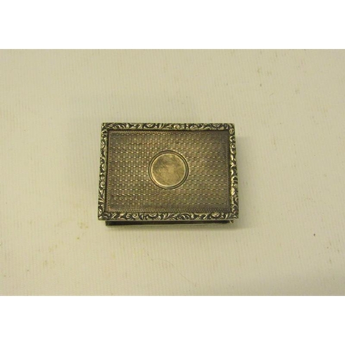 229 - An early 20c Georgian style silver snuff box of rectangular engine turned form with cast leaf and fl... 