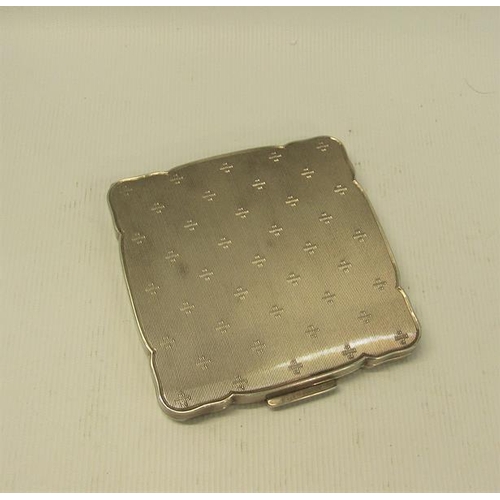 232 - An art deco period German silver compact, engine turned.  925 sterling.  7cms sq.