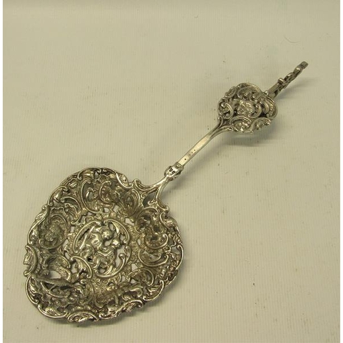 234 - A late Victorian silver decorative tablespoon with cast and pierced ovoid bowl, with terminal rest. ... 