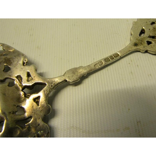 234 - A late Victorian silver decorative tablespoon with cast and pierced ovoid bowl, with terminal rest. ... 