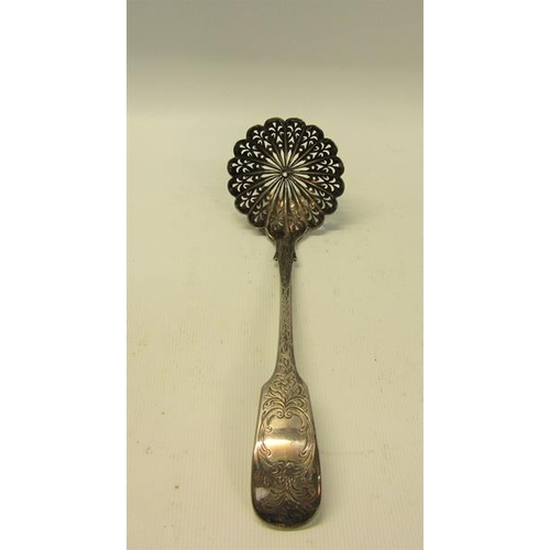 235 - A mid Victorian sifting spoon with a pierced shell shaped bowl and chased handle.  Makers mark for E... 