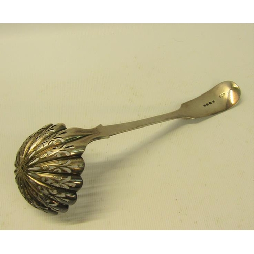 235 - A mid Victorian sifting spoon with a pierced shell shaped bowl and chased handle.  Makers mark for E... 